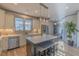 Modern kitchen features stainless steel appliances, granite countertops, and an island with barstool seating at 1624 Tunnel St, Wendell, NC 27591