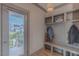 Functional mud room with built-in bench, shelving, and coat hooks, with door to the outside at 1624 Tunnel St, Wendell, NC 27591