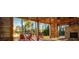Cozy outdoor patio area with a stone fireplace, red Adirondack chairs, and lake views at 1624 Tunnel St, Wendell, NC 27591