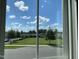 Bright window view overlooking a lush green common area, showcasing the neighborhood's serene and open space at 1624 Tunnel St, Wendell, NC 27591