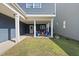 Backyard patio area with seating, view of the yard and blue siding with white trim on the house at 1625 Main Divide Dr, Wake Forest, NC 27587