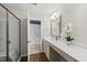 Bathroom vanity featuring a decorative mirror, and a tiled shower at 1625 Main Divide Dr, Wake Forest, NC 27587
