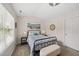 Bedroom featuring neutral walls, a large window and a comfortable-looking wrought iron bed frame with storage bench at 1625 Main Divide Dr, Wake Forest, NC 27587