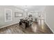 Charming dining area featuring hardwood floors, elegant chandelier, and easy access to the modern kitchen at 1625 Main Divide Dr, Wake Forest, NC 27587