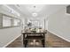 Bright dining area with modern light fixture, wooden floors, and stylish bench seating at 1625 Main Divide Dr, Wake Forest, NC 27587
