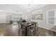 Open dining and living area featuring modern decor, hard wood floors, and lots of natural light at 1625 Main Divide Dr, Wake Forest, NC 27587