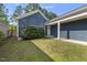 Exterior of home with blue siding, well-maintained lawn, and attached covered area and garage at 1625 Main Divide Dr, Wake Forest, NC 27587