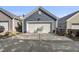 Two car garage, concrete driveway, blue siding, and easy access to back yard and back of the home at 1625 Main Divide Dr, Wake Forest, NC 27587