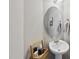 Cozy half bathroom featuring pedestal sink, decorative mirror, and stylish accessories at 1625 Main Divide Dr, Wake Forest, NC 27587