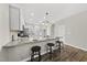 Modern kitchen features granite counters, stainless appliances, and bar stool seating at the island at 1625 Main Divide Dr, Wake Forest, NC 27587