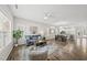 Open living room and dining area with hardwood floors and natural light pouring in from bright windows at 1625 Main Divide Dr, Wake Forest, NC 27587