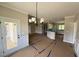 Open-concept living area featuring elegant lighting and access to the kitchen and outdoor porch at 168 Clayton Rd, Princeton, NC 27569