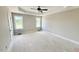 Spacious main bedroom featuring a tray ceiling, neutral walls, and plenty of natural light at 168 Clayton Rd, Princeton, NC 27569