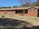 Charming brick home with a covered front porch and spacious front yard at 1802 Holiday Rd, Sanford, NC 27330