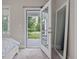 Bedroom with an open glass door that goes out to a screened-in porch overlooking the yard at 1804 Amberly Ledge Way, Cary, NC 27519
