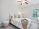 A cozy bedroom features a comfortable bed, a white nightstand and a window at 1804 Amberly Ledge Way, Cary, NC 27519