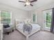 Bedroom features a ceiling fan, neutral color scheme, natural light, and a door to the outside at 1804 Amberly Ledge Way, Cary, NC 27519