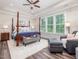 Spacious main bedroom features a four-poster bed, sitting area and a large window at 1804 Amberly Ledge Way, Cary, NC 27519