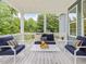Cozy covered patio with stylish furniture, offering a relaxing outdoor space with natural light at 1804 Amberly Ledge Way, Cary, NC 27519