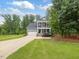 Beautiful blue two story home featuring a long driveway and well maintained lawn at 1804 Amberly Ledge Way, Cary, NC 27519