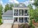 Charming two-story home with a welcoming front porch, a garage and well-maintained landscaping at 1804 Amberly Ledge Way, Cary, NC 27519