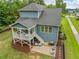 Aerial view of a two-story home with covered deck, patio, and manicured lawn at 1804 Amberly Ledge Way, Cary, NC 27519