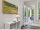 Bright hallway featuring a console table and view of the outside deck with outdoor seating at 1804 Amberly Ledge Way, Cary, NC 27519