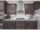 Modern kitchen with stainless steel appliances, dark cabinetry and white subway tile backsplash at 1804 Amberly Ledge Way, Cary, NC 27519