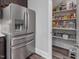 Modern kitchen with stainless steel refrigerator and pantry at 1804 Amberly Ledge Way, Cary, NC 27519