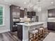 Modern kitchen with an island, stainless steel appliances, and bright recessed lighting at 1804 Amberly Ledge Way, Cary, NC 27519