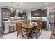 Open-concept kitchen and dining area featuring modern appliances, hardwood floors, and stylish lighting at 1804 Amberly Ledge Way, Cary, NC 27519