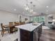 Open floor plan connects kitchen with large island, dining area, and living space at 1804 Amberly Ledge Way, Cary, NC 27519