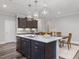 Modern open kitchen boasts center island with sink and dining area at 1804 Amberly Ledge Way, Cary, NC 27519