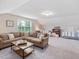 Inviting living room features a large sectional sofa, a window, and additional seating areas for guests at 1804 Amberly Ledge Way, Cary, NC 27519