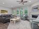 Inviting living room with a fireplace, large windows, and comfortable sofa at 1804 Amberly Ledge Way, Cary, NC 27519
