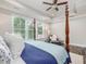 A beautiful main bedroom with a four-poster bed, large windows, and a sitting area at 1804 Amberly Ledge Way, Cary, NC 27519