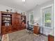Well-appointed office with built-in shelving, a comfortable workspace, and natural light from the windows at 1804 Amberly Ledge Way, Cary, NC 27519