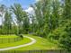 Fenced path leading to a wooded park area at 1804 Amberly Ledge Way, Cary, NC 27519