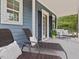 Relaxing outdoor porch with wicker furniture, soft pillows and a view of the lush greenery at 1804 Amberly Ledge Way, Cary, NC 27519