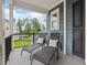 Inviting porch featuring comfortable lounge chairs with white pillows and views of the green outdoors at 1804 Amberly Ledge Way, Cary, NC 27519
