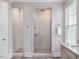 Modern bathroom with a walk-in shower featuring stylish tile work and glass doors at 1804 Amberly Ledge Way, Cary, NC 27519