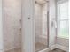 Modern bathroom with a walk-in shower featuring stylish tile work, bench, and glass doors at 1804 Amberly Ledge Way, Cary, NC 27519