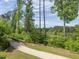 Charming community path with a wooden bridge winding through a lush green landscape at 1804 Amberly Ledge Way, Cary, NC 27519