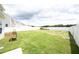 Large backyard with a white fence surrounding the property, grassy lawn, and new construction at 200 Sweet Violet Dr, Youngsville, NC 27596