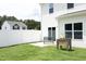 This backyard features a white fence, grassy area, and concrete patio with a bench, perfect for relaxing at 200 Sweet Violet Dr, Youngsville, NC 27596