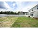 Expansive backyard with a white fence, sunny lawn and ample space for outdoor activities at 200 Sweet Violet Dr, Youngsville, NC 27596