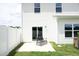 Enclosed backyard with white fence, patio seating and lush grass, ideal for outdoor enjoyment at 200 Sweet Violet Dr, Youngsville, NC 27596