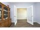Bonus room with French doors opening to another room, hardwood floors, and a wooden china cabinet at 200 Sweet Violet Dr, Youngsville, NC 27596