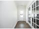 Entry hall featuring wood flooring, a decorated glass door, and French doors leading into another room at 200 Sweet Violet Dr, Youngsville, NC 27596