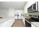 Modern kitchen featuring stainless steel appliances, white cabinetry, and an island with granite countertop at 200 Sweet Violet Dr, Youngsville, NC 27596
